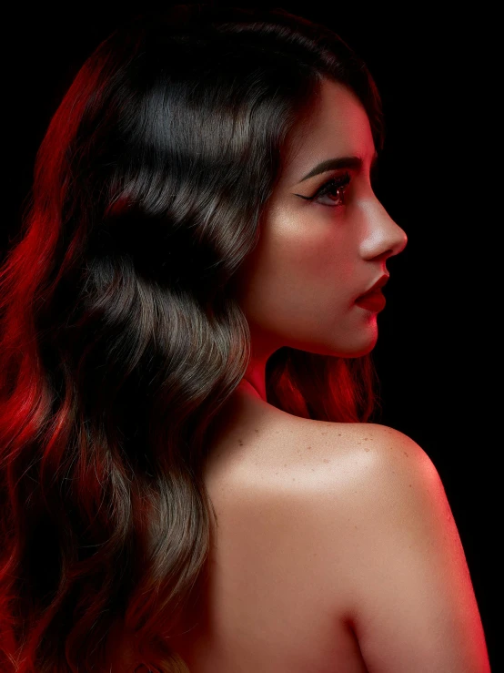 a woman with dark hair standing in front of a black background