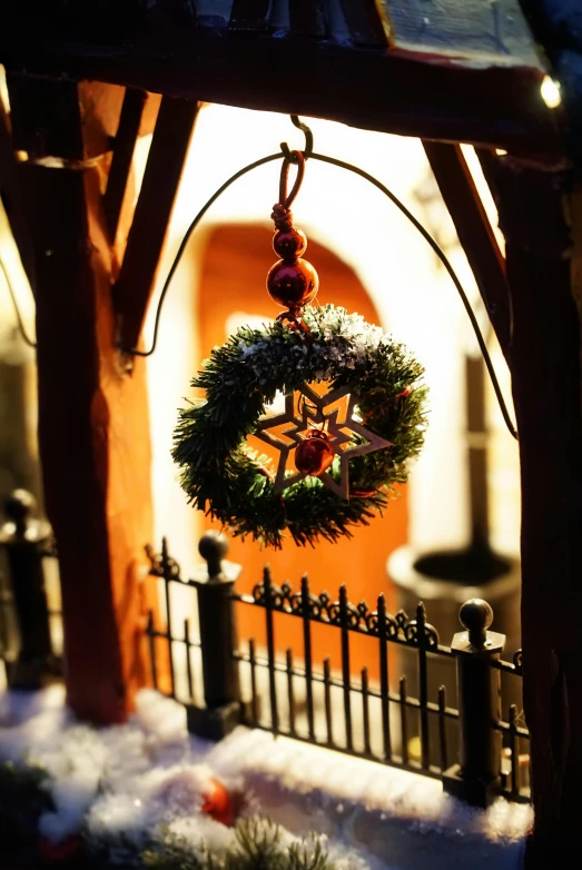 an arch is adorned with wreaths and bells