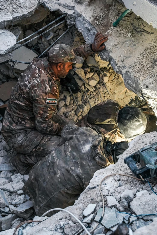 a soldier is laying in the mud while looking through a hole