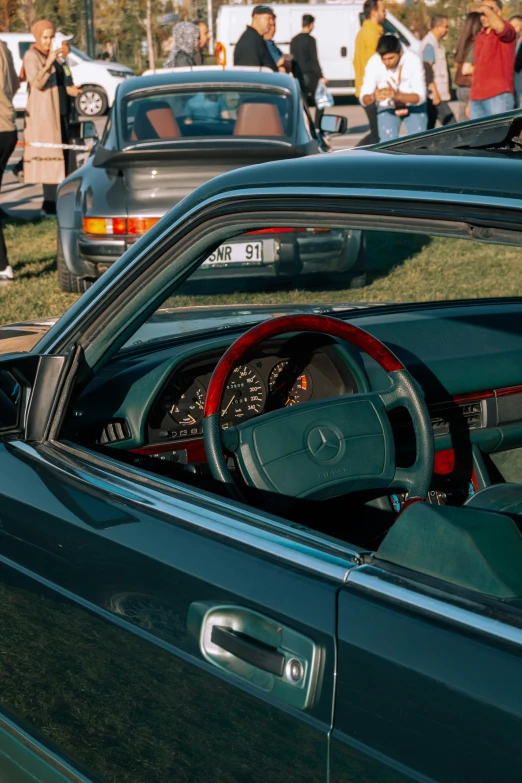 the dashboard of a car in a large car show