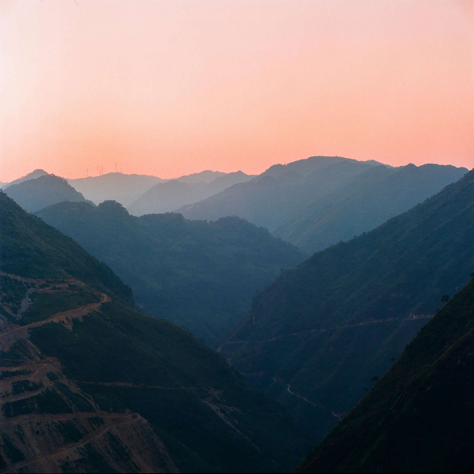 a mountain range with hills and a highway