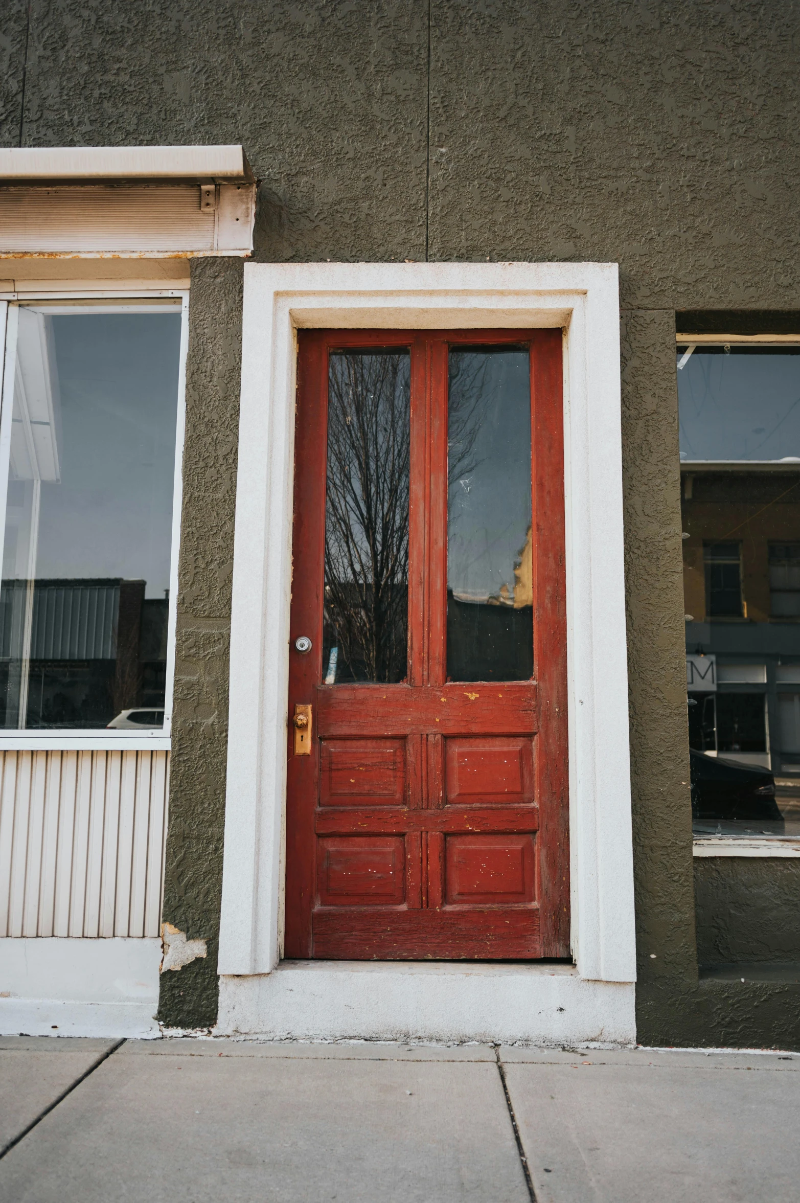 an orange door that has a window in it