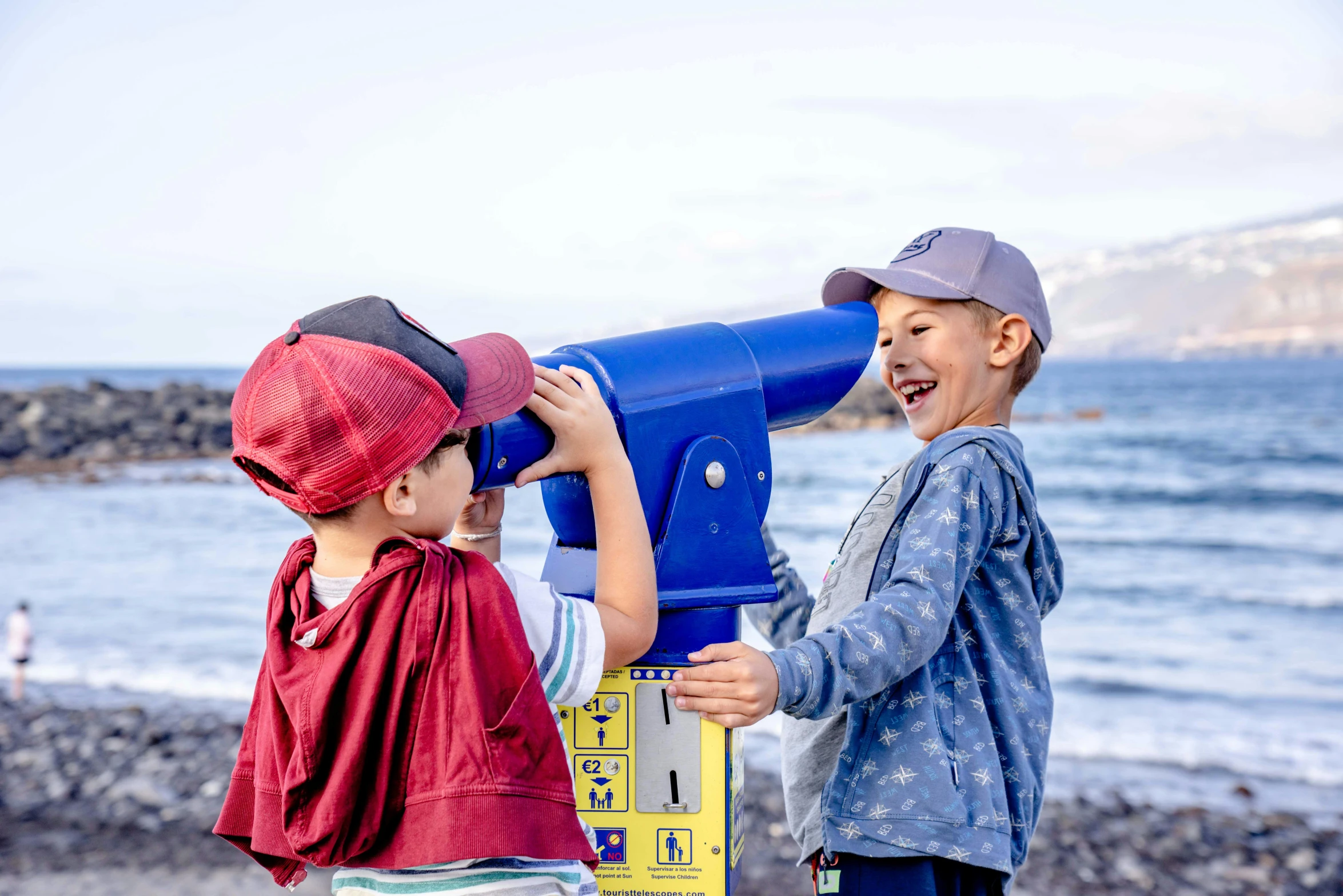 two children are looking through a binch to see soing