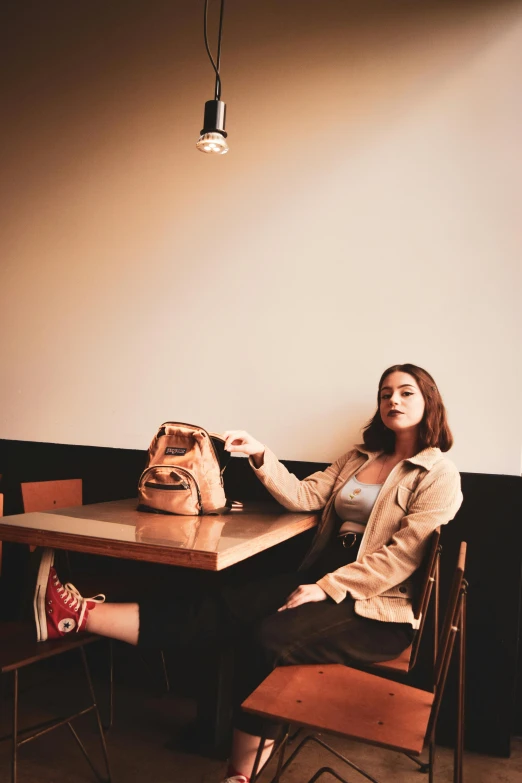 a woman in a long sweater sitting at a table