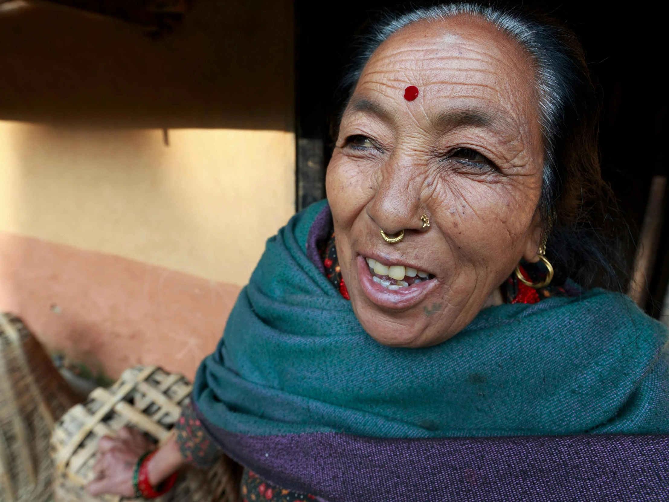 a woman with big hoops smiles at the camera