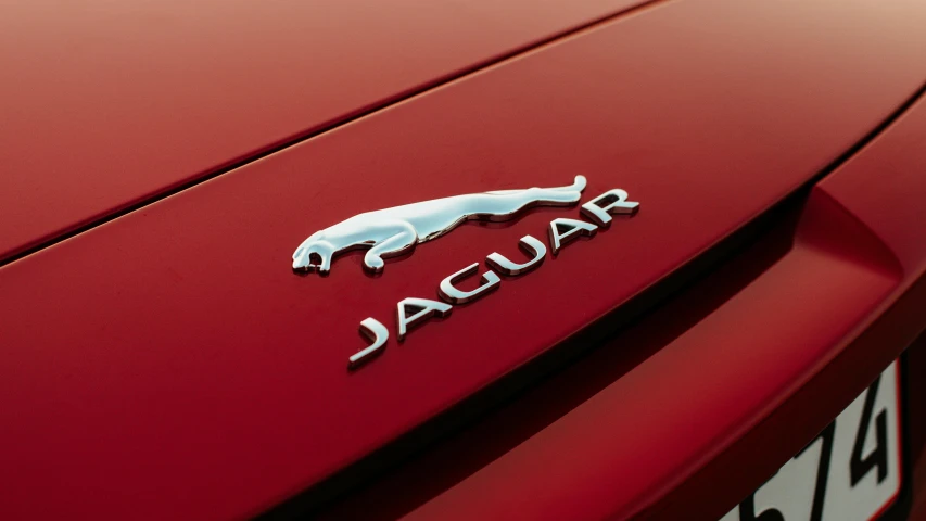 the jaguar badge on the back of a red sports car