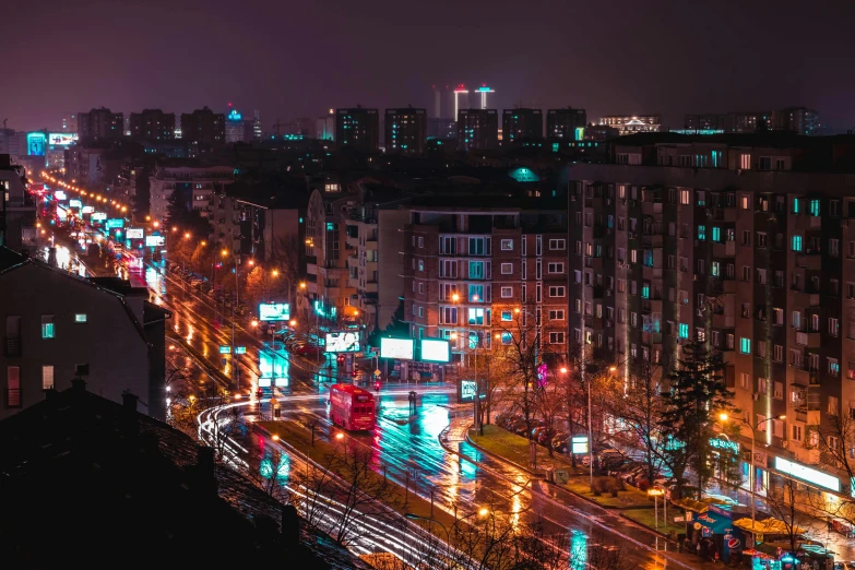 an urban city at night is lit up with street lights