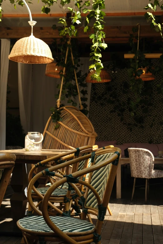 two hanging wicker chairs with a light