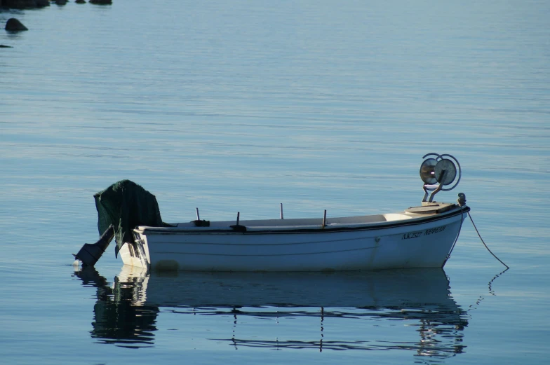 the white boat in the blue water looks as though it was floating in the clear water