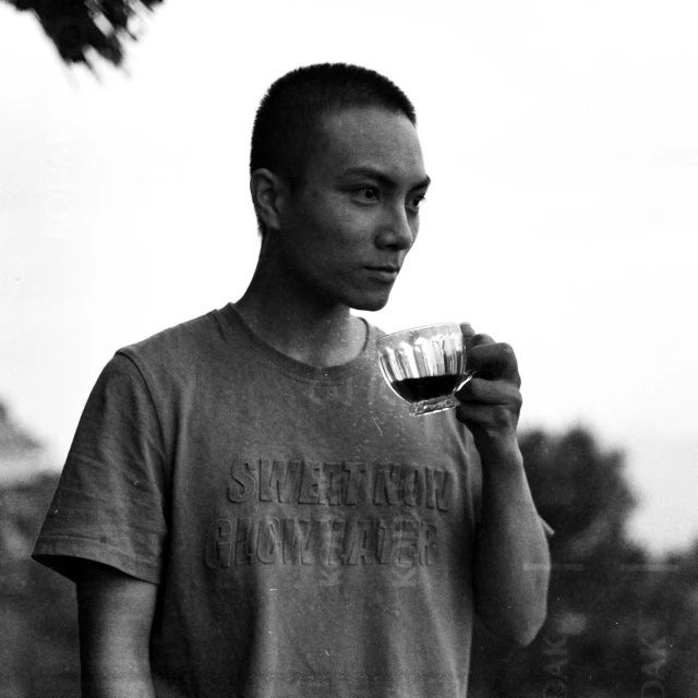 a man holds a glass in his left hand