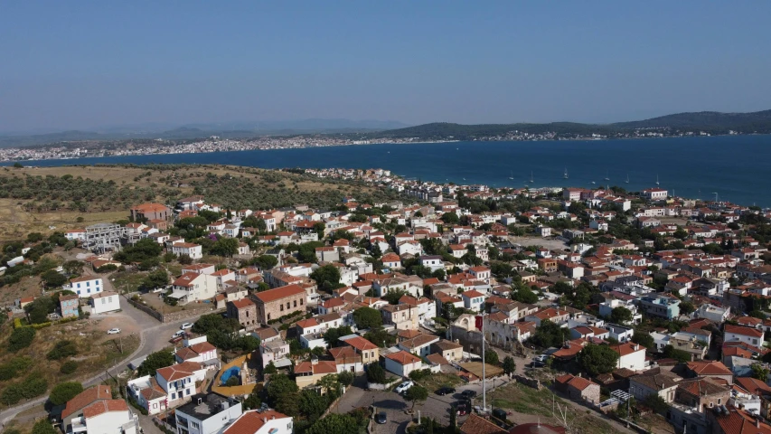 a village sitting in front of a body of water