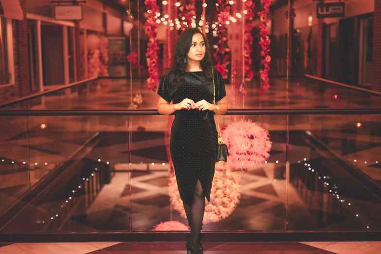 a woman is posing in front of a christmas display