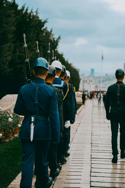 a group of police officers stand at the edge of a bridge