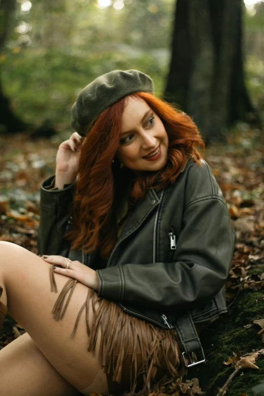 young woman with red hair sitting on the ground