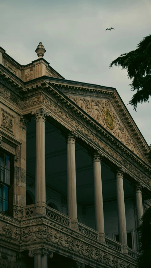 an old mansion with marble columns and pillars