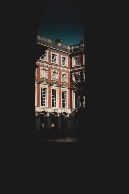 a building with many windows reflecting off the water