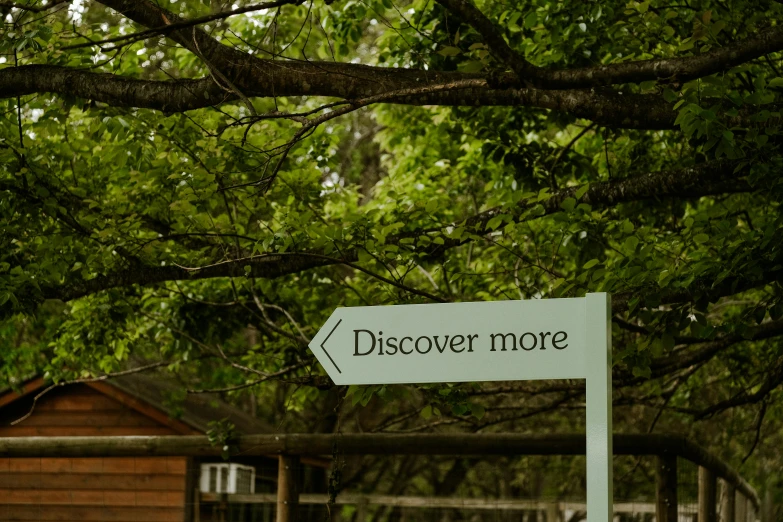 a wooden fence and sign that reads discovering more