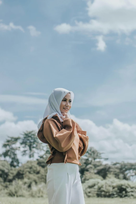 a woman standing on top of a field