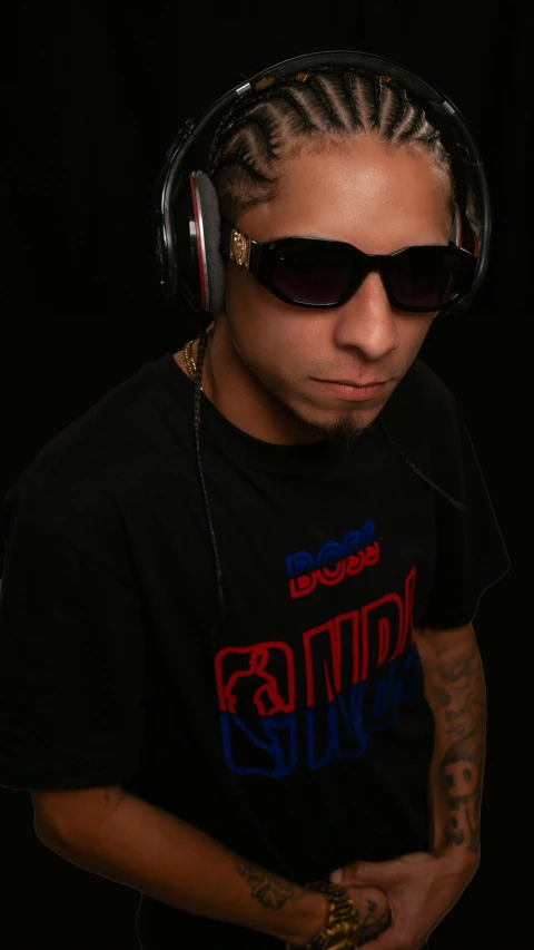 a young man wearing headphones and sunglasses