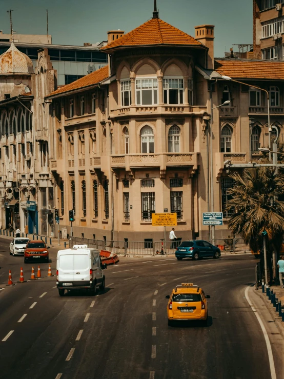 several vehicles driving on an ornate city street