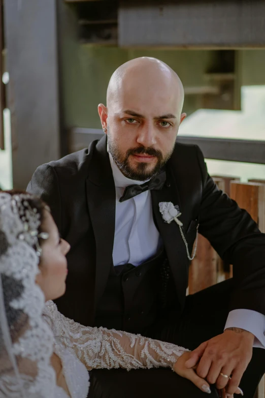 a bride and groom are sitting side by side