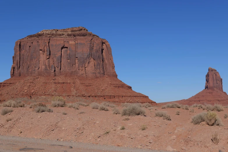 a large red rock formation on the desert side