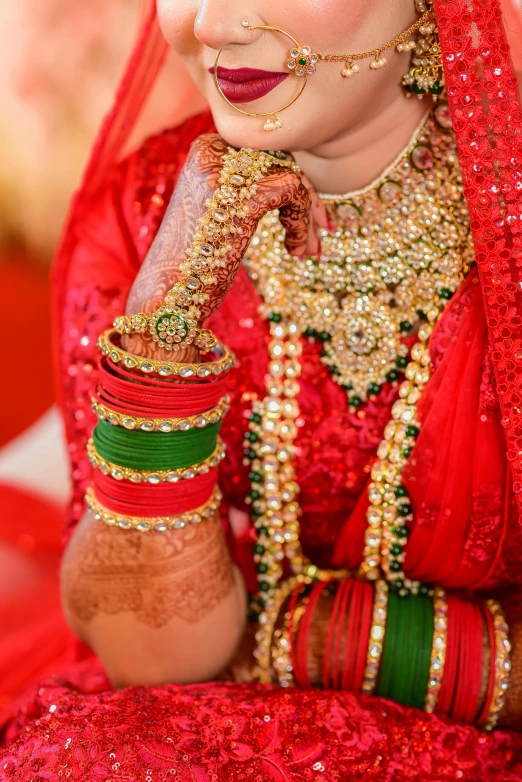 a bride in red has the red veil with gold jewelry