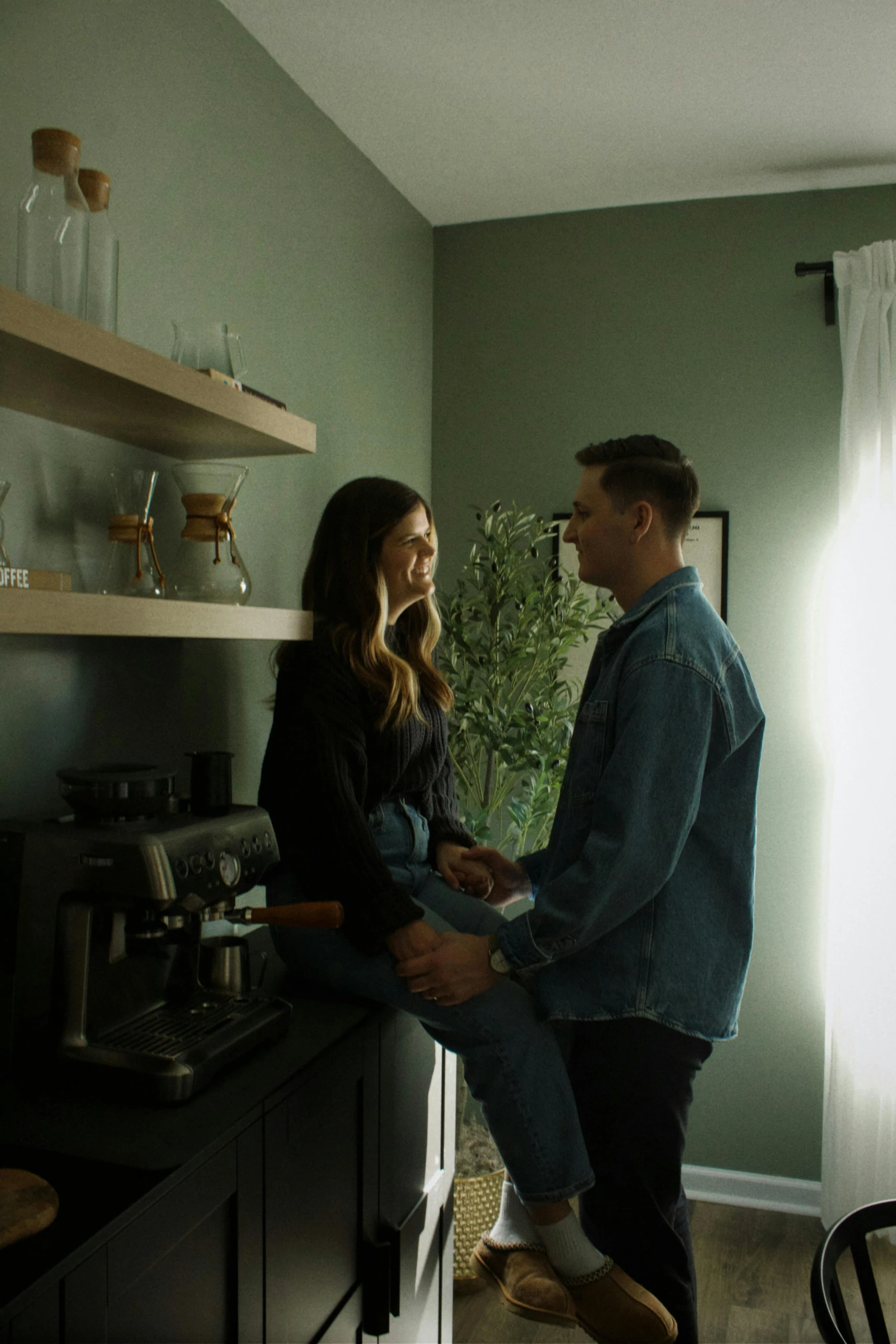 a man sitting next to a woman on top of a counter