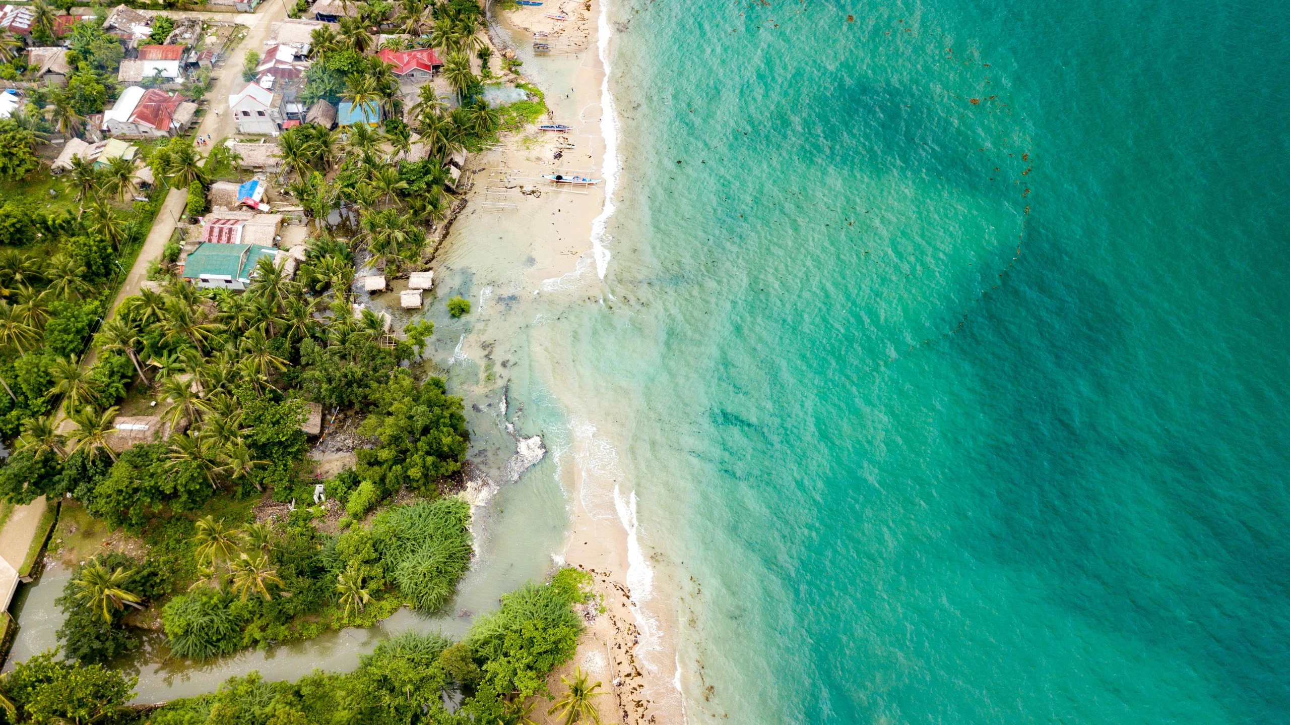 a very pretty beach next to the ocean