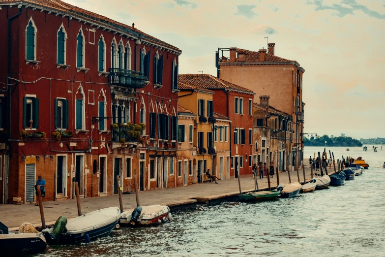 a row of boats docked on the side of a river