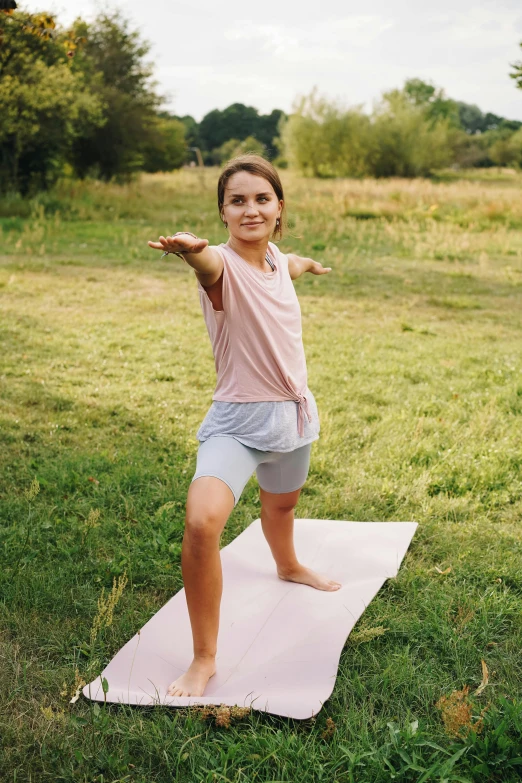 a little girl stretching while on top of a mat