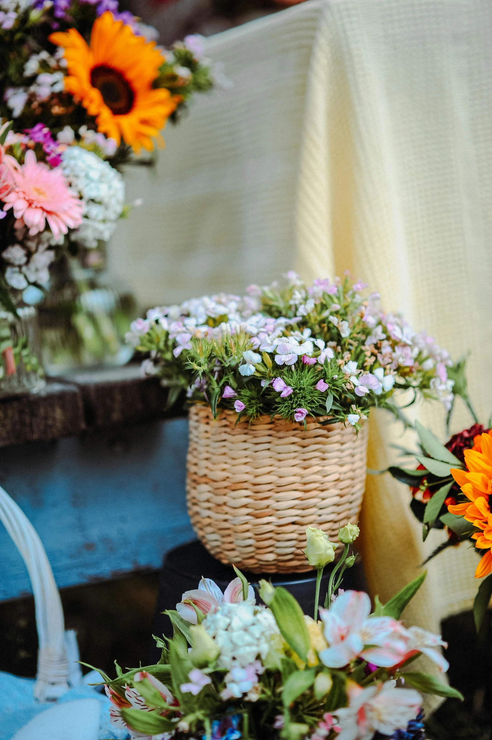 flowers sitting in small wicker baskets on the ground