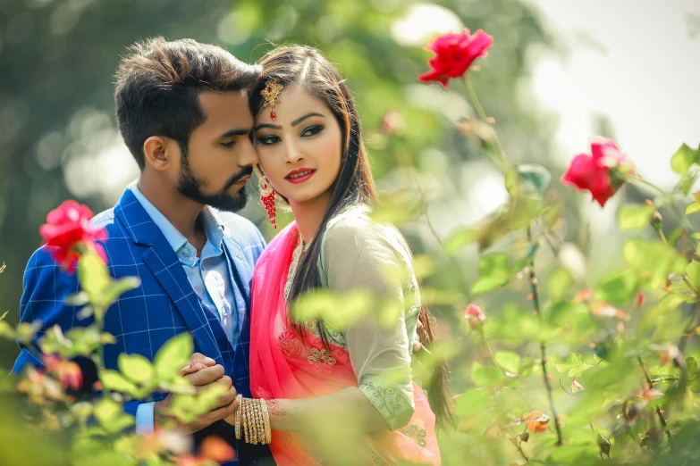 a man and a woman are standing in the flowers together