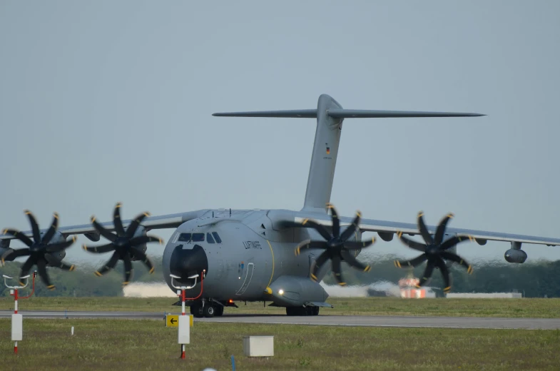 airplane has propellers trailing behind it on a runway