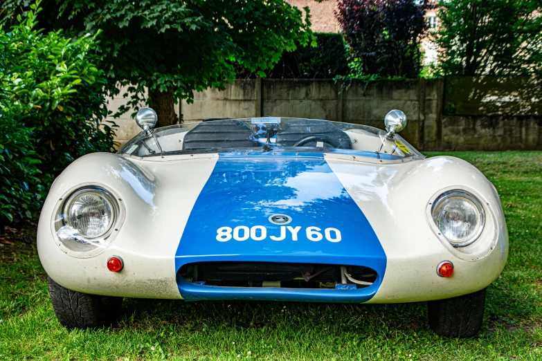 a white and blue car on some grass