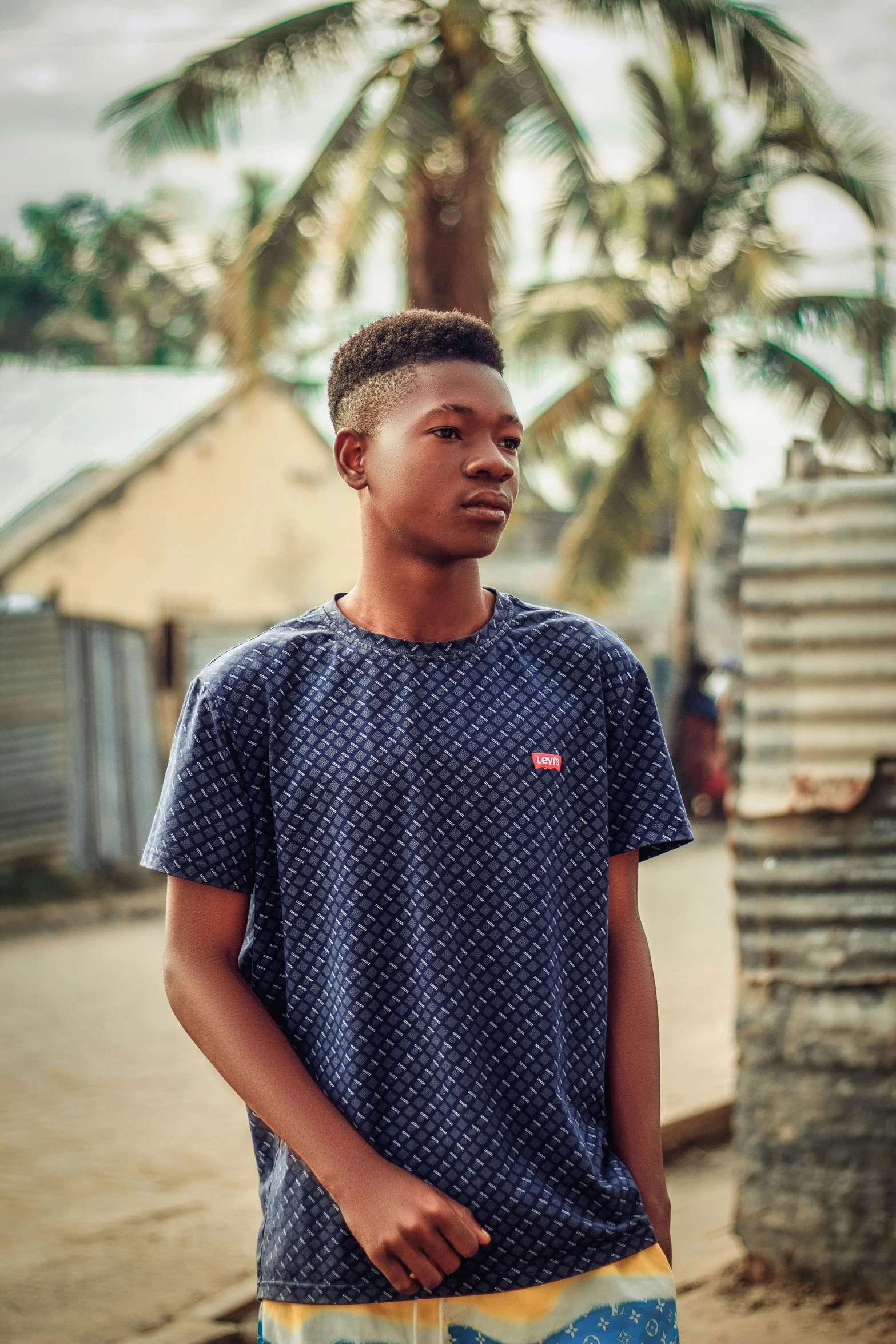 a man in a blue shirt is walking outside