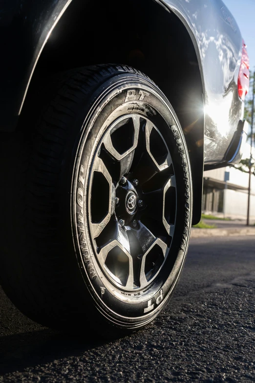 the side tire of a car sitting on the street