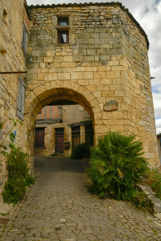 an archway leads into a building that is made of stone