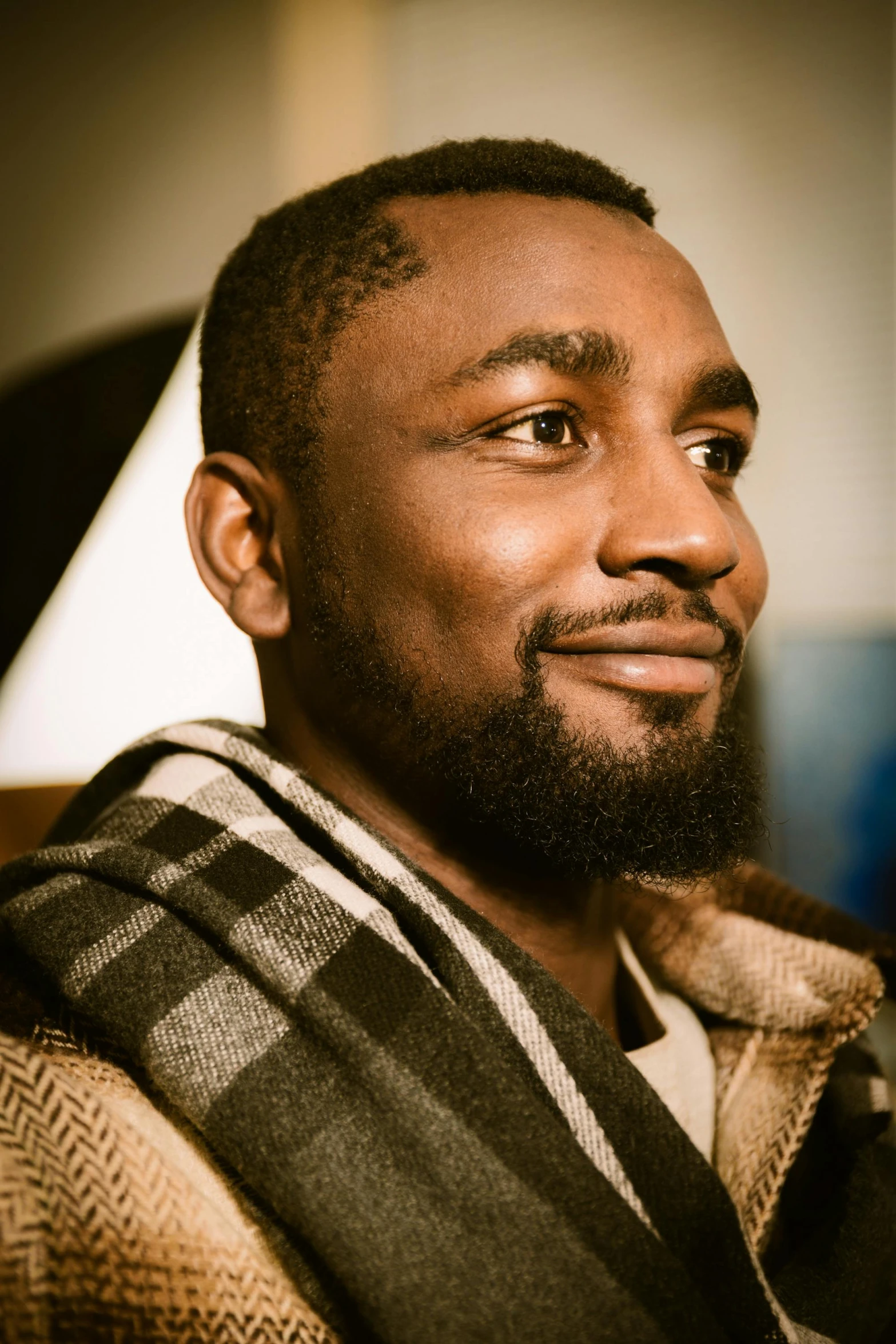 a black man with a beard wearing a scarf