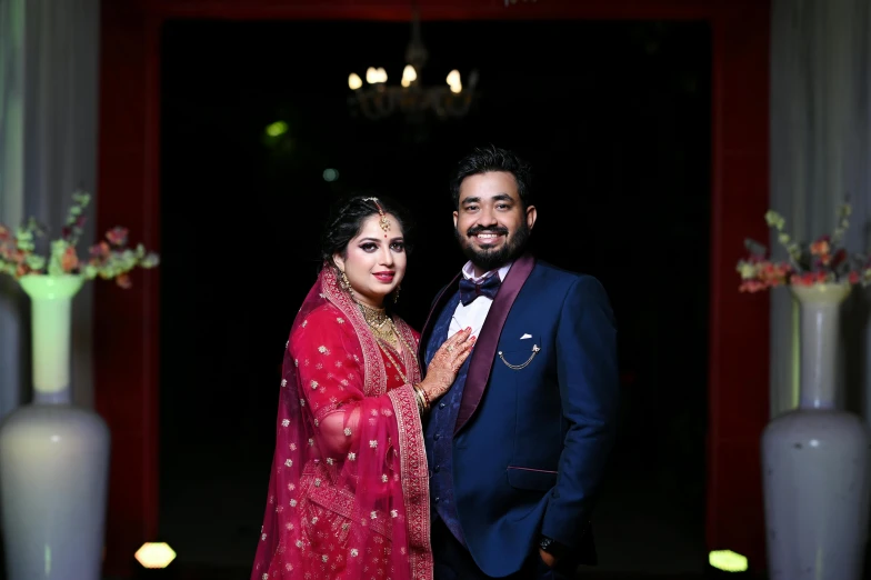 a couple poses for a pograph in an indian reception