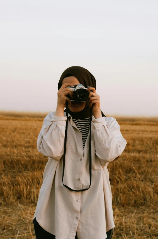 a woman is taking a pograph with her camera