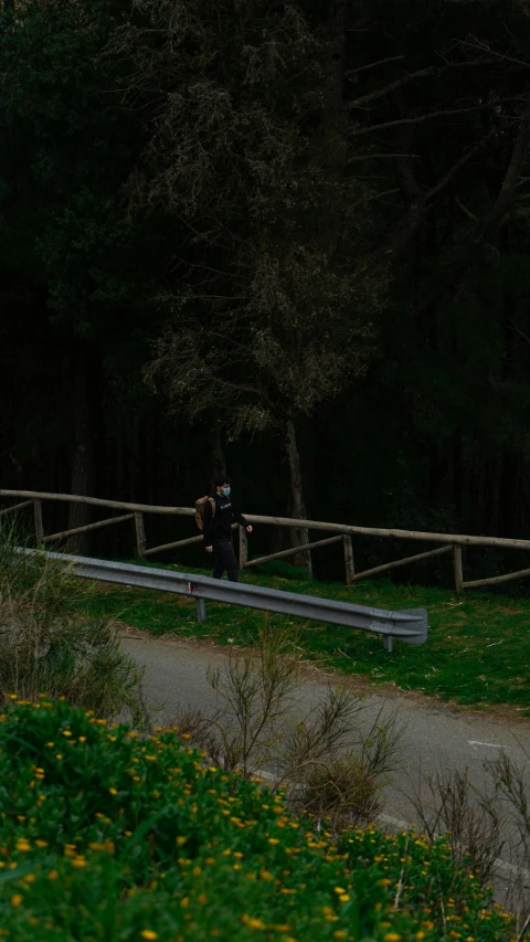 two people standing on top of a wooden bench