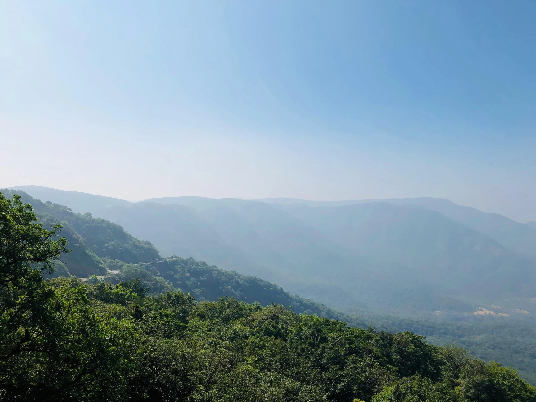 a scenic mountain scene is pographed from an overlook point