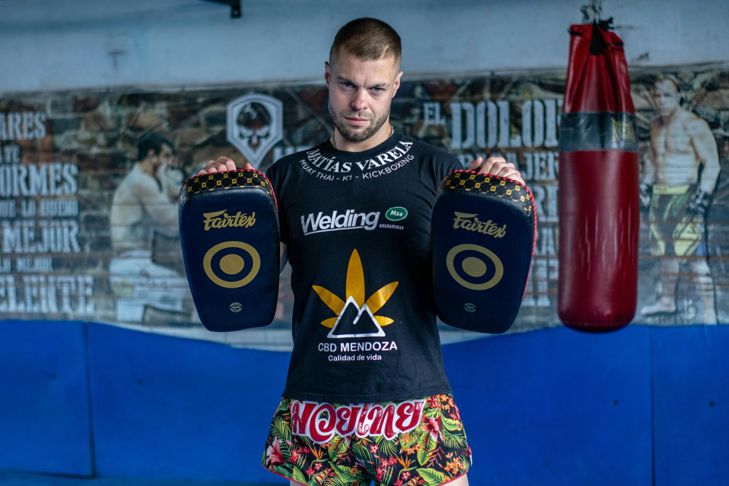 a man standing in front of a boxing punching bag