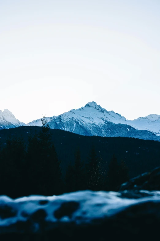 mountains at dusk with white snow on them