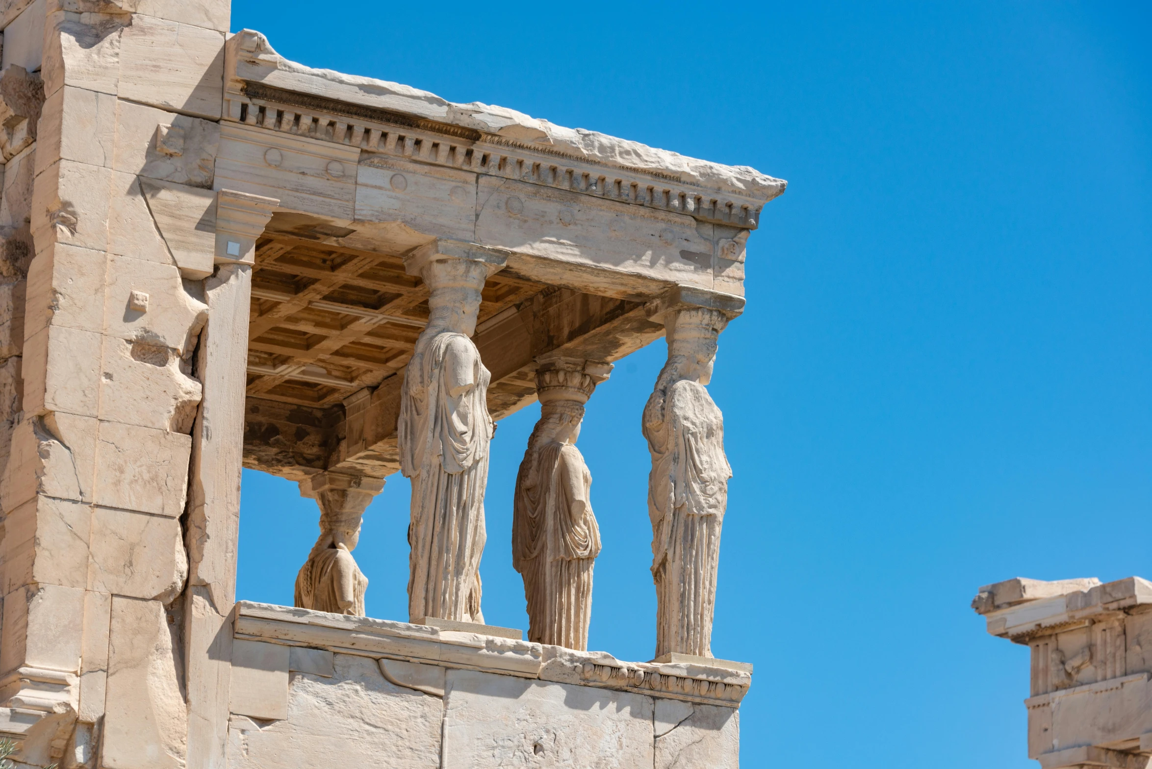 three statues on the top of the roof of a building