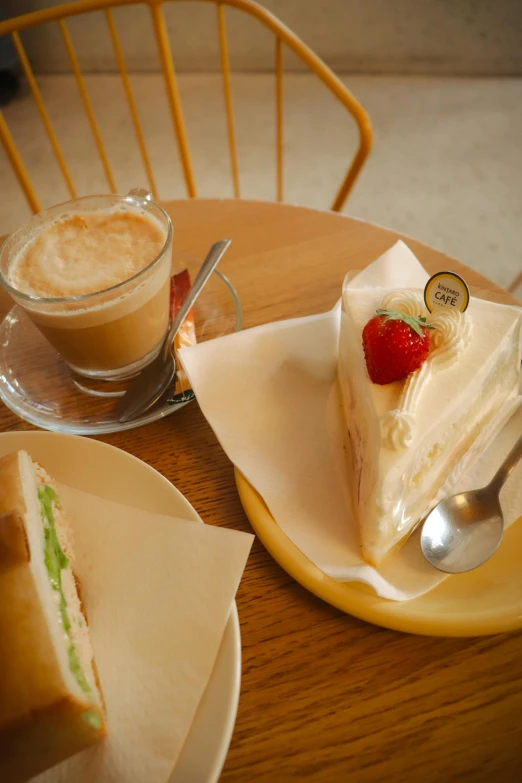 a table that has plates and cups with deserts on it