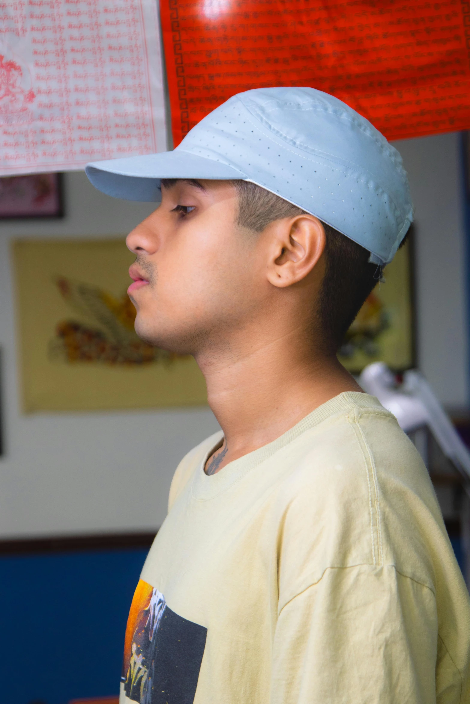 a young man with a light blue hat on