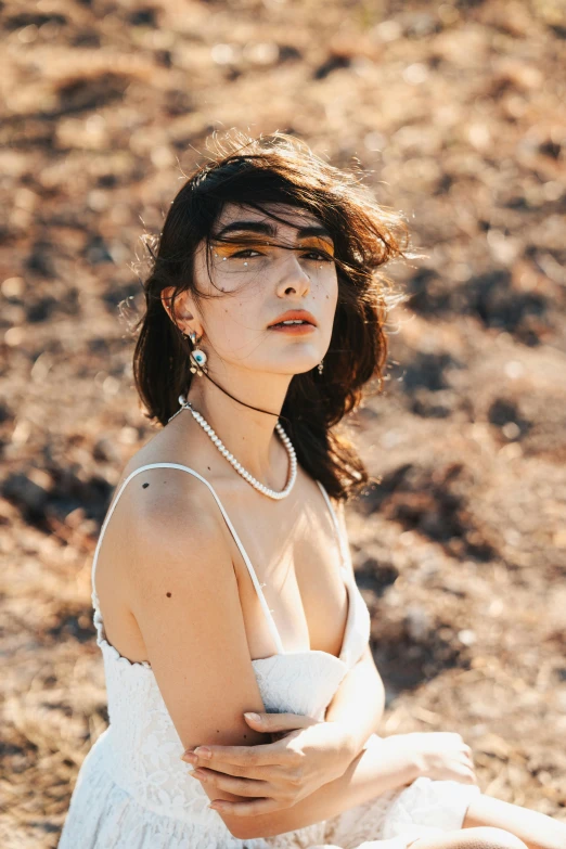 woman in white dress with pearls and necklace