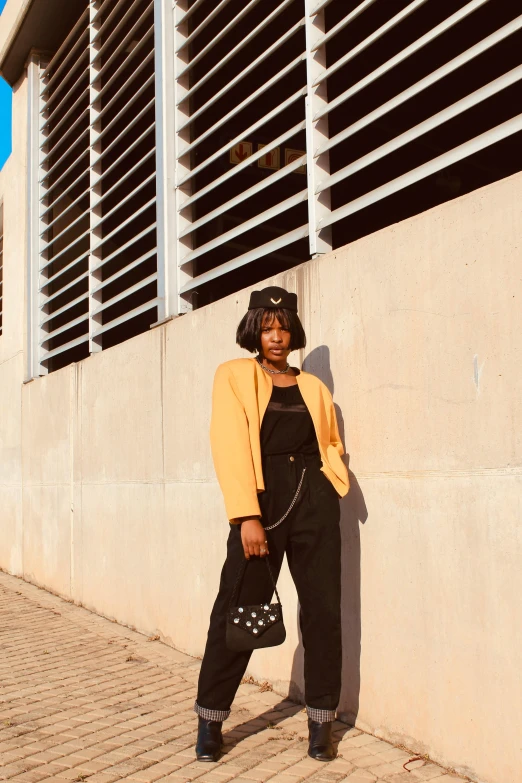 an image of a woman standing outside leaning against a building